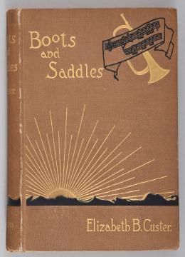 Brown book cover titled "Boots and Saddles" by Elizabeth B. Custer. Features a trumpet with a musical score and a sun rising over a mountain range.