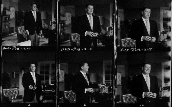A black-and-white contact sheet shows six photos of a man in a suit posing in a living room, holding a cup or saucer in several images. Handwritten notes and frame numbers appear on the borders.