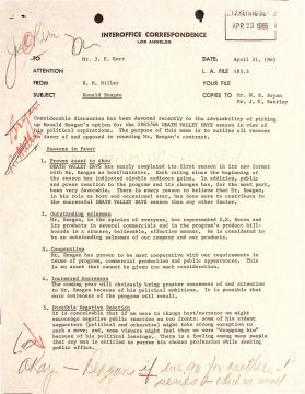 A typed interoffice memo from 1965 discusses Ronald Reagan as a host for "DEATH VALLEY DAYS," with handwritten notes and signatures in red ink around the text, highlighting, underlining, and marking certain sections.