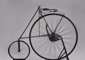 top half of a bicycle wheel, with the seat and handle bars attached above it