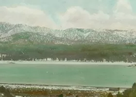 landscape of lake surrounded by snowy mountains