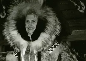 woman dressed in heavy winter coat with fur hood