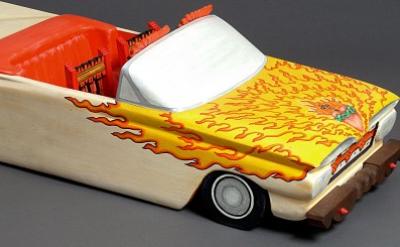 sculptrue of a convertible car with flames painted on the hood