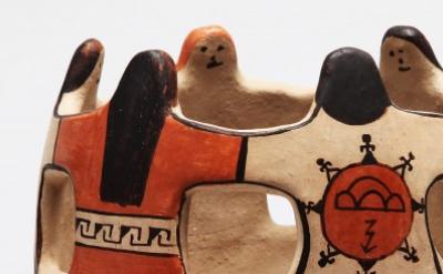 close-up of ceramic bowl shaped like people holding hands in a circle