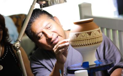 Native artist working on ceramic vase