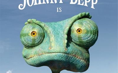 A quirky, big-eyed chameleon wearing a red Hawaiian shirt stands in a desert with cacti. The text reads “Johnny Depp is Rango.” The sky is clear and blue.