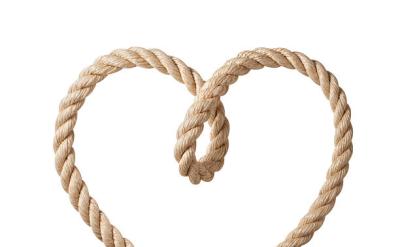 A brown rope twisted into the shape of a heart, with the ends crossing at the bottom, on a white background.
