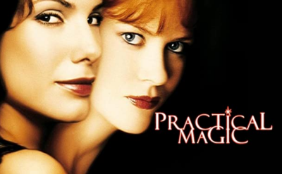 Two women stand close together against a black background. The words "Practical Magic" are written near their faces in stylized white and orange text.