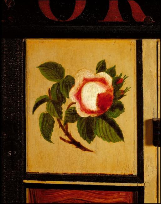 detail of a painted rose on a stagecoach exterior panel