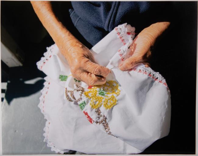 detail of woman stitching