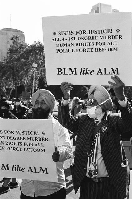 two Sikhs holding BLM signs