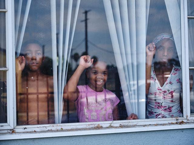 three children looking through the window