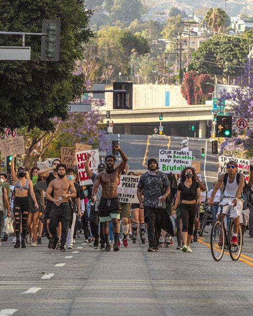 shirtless protesters on road downtown LA