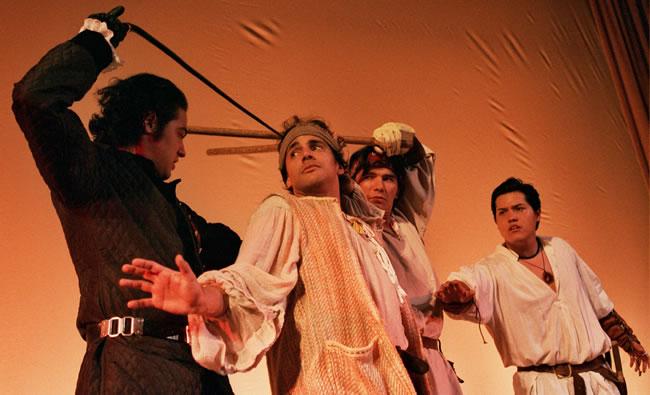 four actors in battle scene on stage