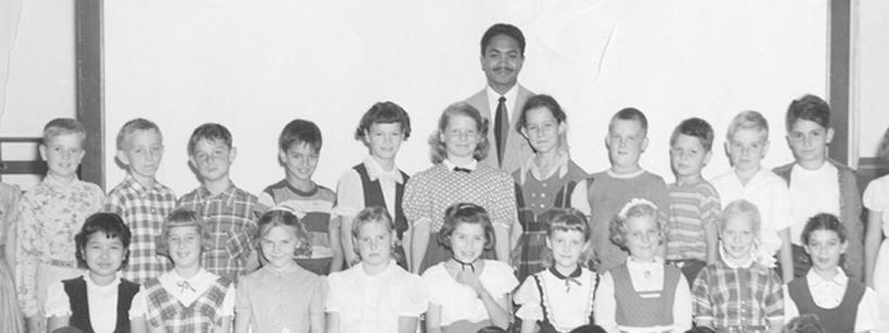 black and white school class picture with Mervyn M. Dymally as teacher standing behind his students