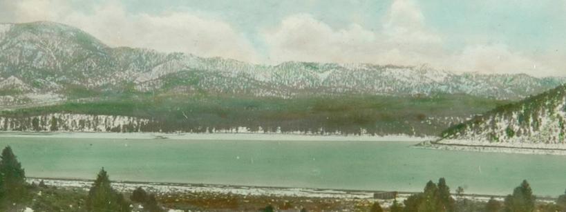 landscape of lake surrounded by snowy mountains