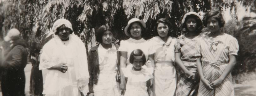 black and white photograph of Native American girls wearing light-colored dresses