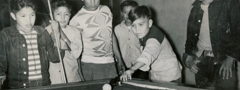 students relaxing by paying pool