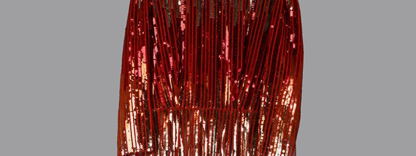A long, ankle-length red dress with three-quarter sleeves, covered in shiny sequins arranged in vertical lines, displayed against a plain gray background.
