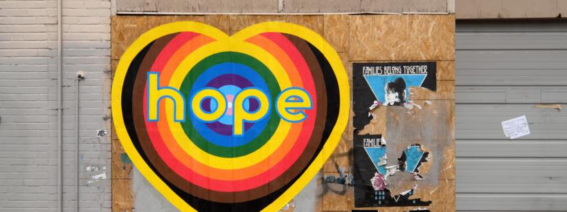 a multi-colored heart icon with the word hope on it