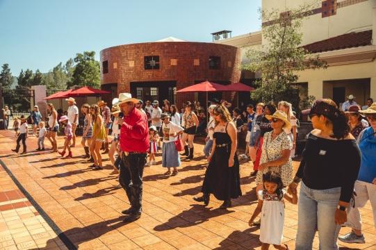 A group of people standing on a brick surface.