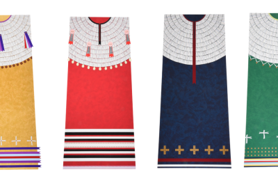 Four traditional Indigenous ribbon dresses in yellow, red, blue, and green, each featuring a white yoke and unique geometric or cross-shaped detailing at the hem.