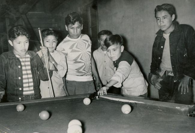 students relaxing by paying pool